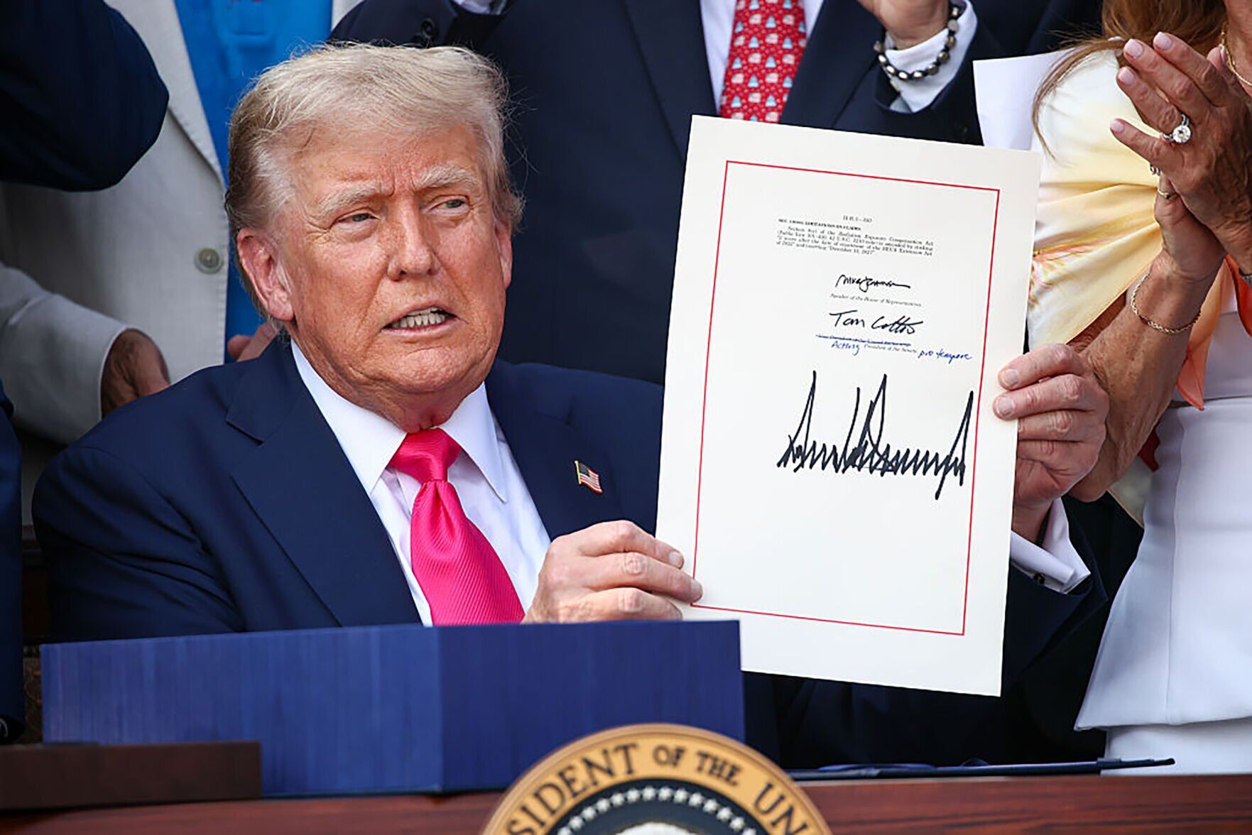 U.S. President Donald Trump, joined by Republican lawmakers, signs the One, Big Beautiful Bill Act into law during an Independence Day military family picnic on the South Lawn of the White House on July 4, 2025, in Washington, D.C.. (copy)
